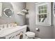 Stylish bathroom with a marble vanity, decorative mirror, and modern fixtures at 960 Pebblestone Ct, Alpharetta, GA 30009
