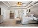 Spacious primary bedroom featuring a tray ceiling, a four poster bed, and neutral paint at 960 Pebblestone Ct, Alpharetta, GA 30009