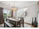 Inviting dining room featuring natural light, modern chandelier, and hardwood floors at 960 Pebblestone Ct, Alpharetta, GA 30009
