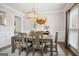 Stylish dining room boasts crown molding, modern lighting and a large window at 960 Pebblestone Ct, Alpharetta, GA 30009