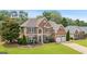 Traditional two-story brick home with manicured lawn, charming curb appeal, and an attached garage at 960 Pebblestone Ct, Alpharetta, GA 30009