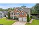 Stately brick home with an attached two-car garage and lush, green landscaping at 960 Pebblestone Ct, Alpharetta, GA 30009