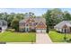 Beautiful brick home boasts a well-kept lawn, blue shutters, and a two-car garage at 960 Pebblestone Ct, Alpharetta, GA 30009