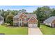 Charming brick two-story home with a well-manicured lawn and lovely landscaping at 960 Pebblestone Ct, Alpharetta, GA 30009