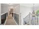 Bright hallway with iron railing, overhead lighting, and views of the bedroom at 960 Pebblestone Ct, Alpharetta, GA 30009
