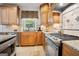 Updated kitchen with granite countertops, stainless steel appliances, and tiled backsplash at 960 Pebblestone Ct, Alpharetta, GA 30009