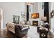 Large living room with fireplace, stylish couches and chairs, and large windows at 960 Pebblestone Ct, Alpharetta, GA 30009
