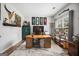 Well-lit home office with custom desk, modern decor, and hardwood floors at 960 Pebblestone Ct, Alpharetta, GA 30009