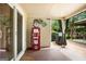 Covered patio with a vintage gas pump, barbecue grill, and wooded backyard views at 960 Pebblestone Ct, Alpharetta, GA 30009