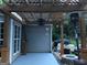 Cozy patio area with a decorative pergola, ideal for outdoor dining and entertaining with string lights at 123 Chippewa Run, Auburn, GA 30011