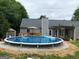 Backyard features a refreshing above-ground pool, perfect for summer relaxation and outdoor entertaining at 123 Chippewa Run, Auburn, GA 30011