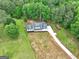 Aerial view of a beautifully landscaped house featuring a long drive and surrounded by lush greenery at 375 Foster Dr, Mcdonough, GA 30253