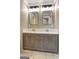 Modern bathroom with a double sink vanity, granite countertop, and contemporary lighting fixtures at 375 Foster Dr, Mcdonough, GA 30253
