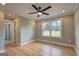 Spacious bedroom showcasing hardwood floors, neutral paint, a ceiling fan, and backyard views at 375 Foster Dr, Mcdonough, GA 30253