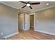 Bedroom featuring hardwood floors, neutral walls, a ceiling fan, closet, and doorways at 375 Foster Dr, Mcdonough, GA 30253