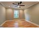 Bedroom with hardwood floors, neutral walls, large window, ceiling fan, and natural light at 375 Foster Dr, Mcdonough, GA 30253
