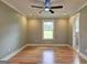 A bright bedroom featuring hardwood floors, neutral paint, a ceiling fan, and a window view at 375 Foster Dr, Mcdonough, GA 30253