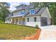 Stunning two-story home with a modern design, lush green lawn, and attached garage at 375 Foster Dr, Mcdonough, GA 30253