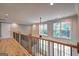 Bright hallway with wood floors, wooden railing and ample natural light from the large windows at 375 Foster Dr, Mcdonough, GA 30253