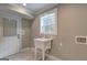 Well-lit laundry room with a utility sink and a view to the outdoors at 375 Foster Dr, Mcdonough, GA 30253