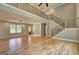 Inviting living room with hardwood floors, stairs, and a view to the entry door at 375 Foster Dr, Mcdonough, GA 30253