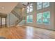 Bright and airy living room with hardwood floors, tall windows, and a staircase at 375 Foster Dr, Mcdonough, GA 30253