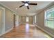 Expansive living room with hardwood floors, ceiling fan, and ample windows at 375 Foster Dr, Mcdonough, GA 30253