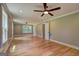 Spacious living room with hardwood floors, multiple windows, and ceiling fans at 375 Foster Dr, Mcdonough, GA 30253