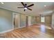 Large living room featuring hardwood floors, dual ceiling fans, and neutral walls at 375 Foster Dr, Mcdonough, GA 30253