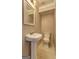 Bright powder room with a pedestal sink, toilet, and neutral color palette at 375 Foster Dr, Mcdonough, GA 30253