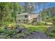 Lush backyard with mature trees and thoughtful landscaping at 157 Rockspray Rdg, Peachtree City, GA 30269