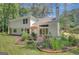 Spacious backyard featuring a patio, lush landscaping, and mature trees at 157 Rockspray Rdg, Peachtree City, GA 30269