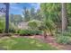 Expansive backyard with lawn, lush landscaping, and mature trees creating a tranquil setting at 157 Rockspray Rdg, Peachtree City, GA 30269