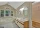 Bright bathroom with a large soaking tub under a window, and double sinks at 157 Rockspray Rdg, Peachtree City, GA 30269