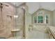 A bright bathroom with a glass shower, soaking tub under a window, and double sinks at 157 Rockspray Rdg, Peachtree City, GA 30269