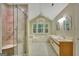 A bright bathroom featuring a glass shower and a window over a soaking tub at 157 Rockspray Rdg, Peachtree City, GA 30269
