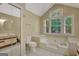 A light, bright bathroom with a garden tub and a window with wooded views at 157 Rockspray Rdg, Peachtree City, GA 30269