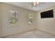 Bright bedroom with large windows, neutral carpet, and a mounted television at 157 Rockspray Rdg, Peachtree City, GA 30269