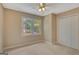 Neutral bedroom with bright windows, carpet flooring, and standard closet doors at 157 Rockspray Rdg, Peachtree City, GA 30269