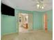 Bright bedroom with an ensuite bathroom, ceiling fan, and large picture window at 157 Rockspray Rdg, Peachtree City, GA 30269