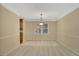 Neutral dining room with a large window, carpet, and overhead chandelier lighting at 157 Rockspray Rdg, Peachtree City, GA 30269