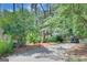 Lush, wooded driveway leading to a charming home and parked golf cart at 157 Rockspray Rdg, Peachtree City, GA 30269