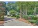 Scenic driveway leading to a charming home and lush landscaping at 157 Rockspray Rdg, Peachtree City, GA 30269