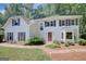 Beautifully landscaped two-story home with a well-manicured lawn and a red front door at 157 Rockspray Rdg, Peachtree City, GA 30269