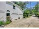 Three car garage with white exterior and well manicured shrubbery at 157 Rockspray Rdg, Peachtree City, GA 30269