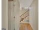 Bright hallway with wood floors leading to the staircase and featuring a convenient closet space at 157 Rockspray Rdg, Peachtree City, GA 30269