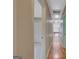 Hallway with hardwood floors with view to a carpeted bedroom and stairwell at 157 Rockspray Rdg, Peachtree City, GA 30269