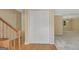 Hallway with wood floor and carpeted room with a stairway with a wooden railing at 157 Rockspray Rdg, Peachtree City, GA 30269