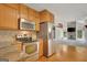 Open kitchen design offers stainless appliances, granite counters, and hardwood floors at 157 Rockspray Rdg, Peachtree City, GA 30269