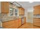 Kitchen with light wood cabinets, granite counters, stainless dishwasher, and hardwood flooring at 157 Rockspray Rdg, Peachtree City, GA 30269